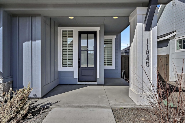 view of exterior entry with board and batten siding