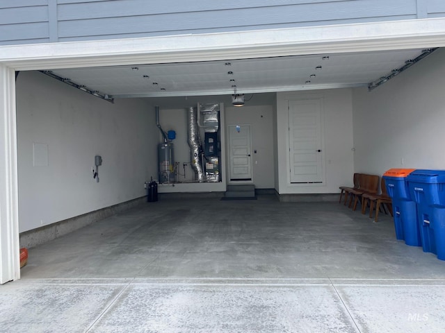 garage featuring gas water heater, heating unit, and a garage door opener