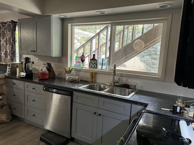 1111 SW 11th Ave, Ontario, OR 97914 - kitchen featuring a sink, black range with electric cooktop, dark countertops, wood finished floors, and dishwasher