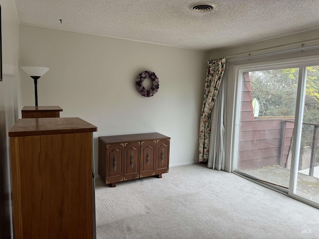 1111 SW 11th Ave, Ontario, OR 97914 - interior space featuring a textured ceiling, access to outside, light carpet, and visible vents