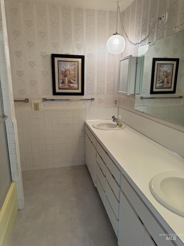 1111 SW 11th Ave, Ontario, OR 97914 - full bath with wallpapered walls, a sink, double vanity, and tile patterned floors