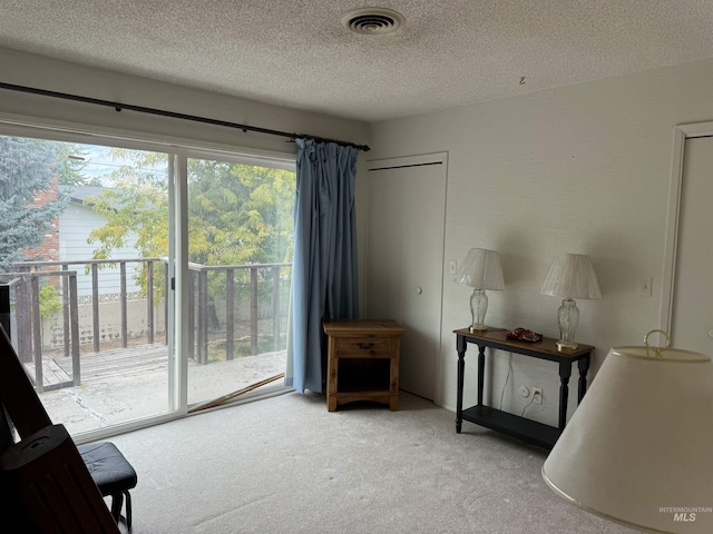 1111 SW 11th Ave, Ontario, OR 97914 - sitting room featuring visible vents, carpet, and a textured ceiling