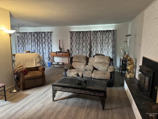 1111 SW 11th Ave, Ontario, OR 97914 - living room featuring a wood stove and wood finished floors