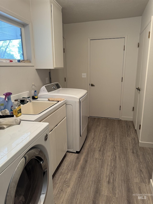 1111 SW 11th Ave, Ontario, OR 97914 - washroom with separate washer and dryer, cabinet space, and wood finished floors