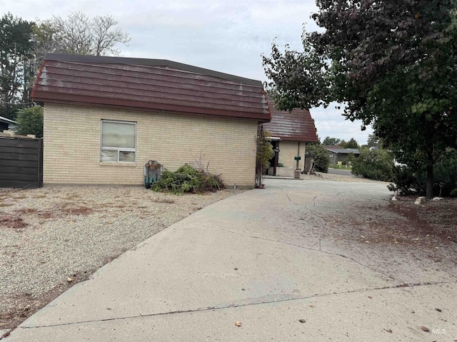 1111 SW 11th Ave, Ontario, OR 97914 - view of property exterior with brick siding, driveway, and mansard roof
