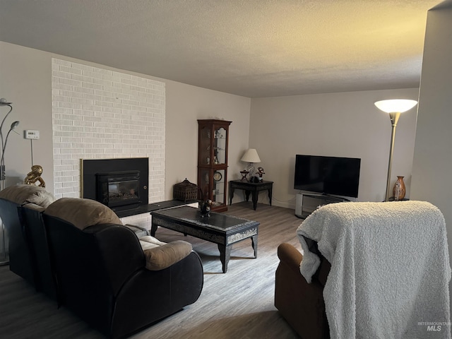 1111 SW 11th Ave, Ontario, OR 97914 - living room with wood finished floors, a textured ceiling, and a fireplace