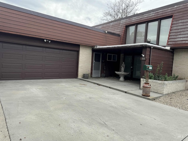 1111 SW 11th Ave, Ontario, OR 97914 - exterior space featuring brick siding, an attached garage, and driveway
