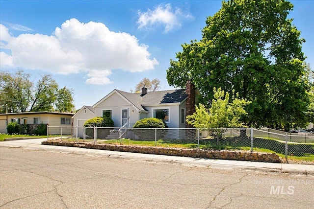 ranch-style house with a fenced front yard, stucco siding, and a chimney
