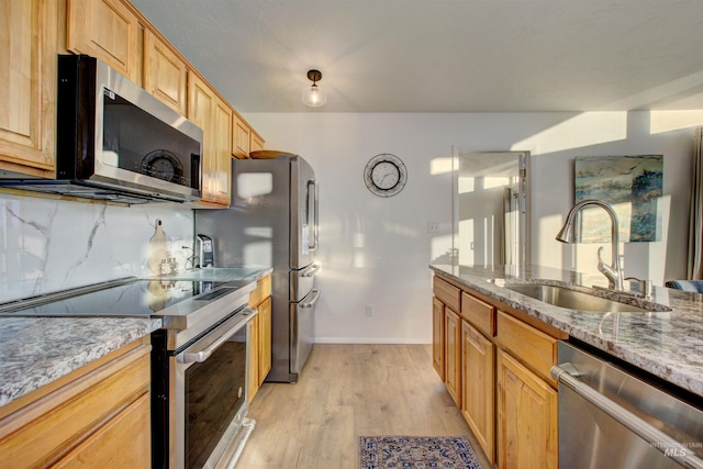 4420 N Ginzel St, Boise, ID 83703 - kitchen featuring tasteful backsplash, light stone counters, appliances with stainless steel finishes, light wood-style floors, and a sink