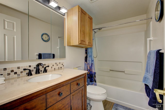 4420 N Ginzel St, Boise, ID 83703 - full bathroom with vanity, wood finished floors, shower / tub combo, toilet, and tasteful backsplash
