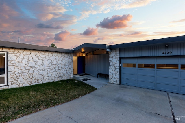 4420 N Ginzel St, Boise, ID 83703 - view of front of property featuring stone siding, an attached garage, and concrete driveway