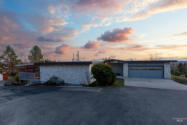 4420 N Ginzel St, Boise, ID 83703 - view of front facade featuring an attached garage, stone siding, and driveway