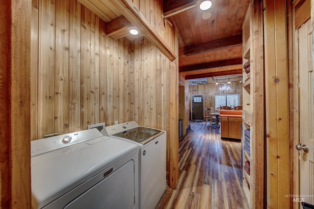 clothes washing area featuring wood ceiling, light hardwood / wood-style floors, separate washer and dryer, and wooden walls