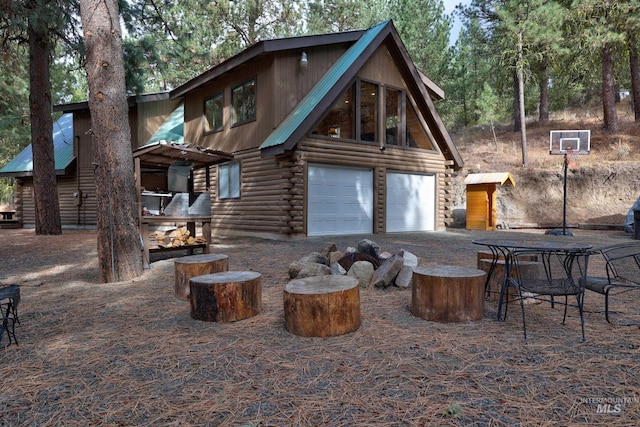 rear view of house featuring a garage