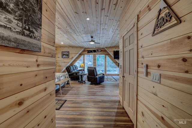 hall with hardwood / wood-style floors, wood ceiling, and wood walls