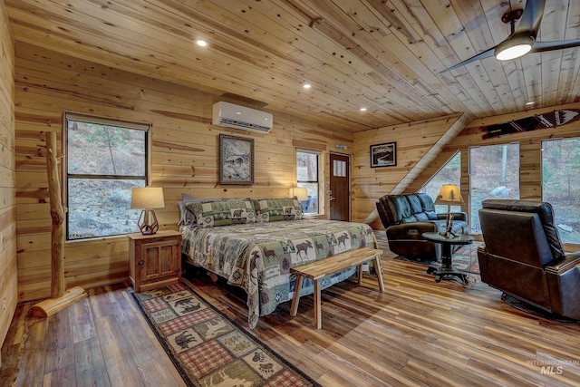 bedroom with wood walls, hardwood / wood-style flooring, and an AC wall unit