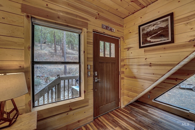 foyer featuring wood walls, hardwood / wood-style flooring, and wooden ceiling