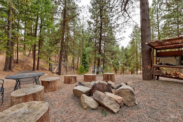 view of yard with an outdoor fire pit