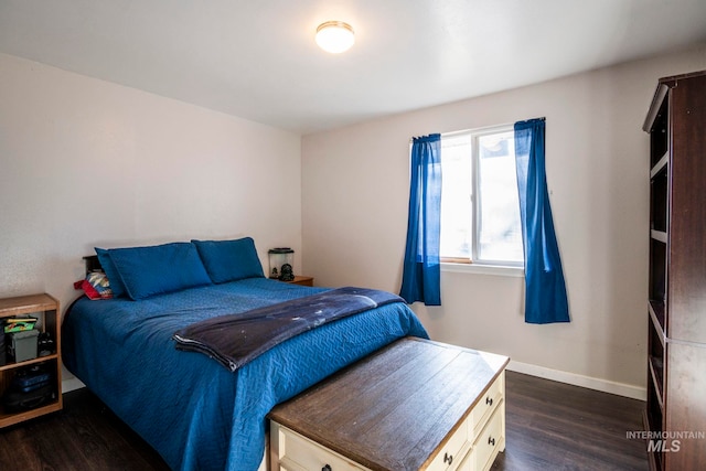 bedroom featuring dark wood-type flooring and baseboards