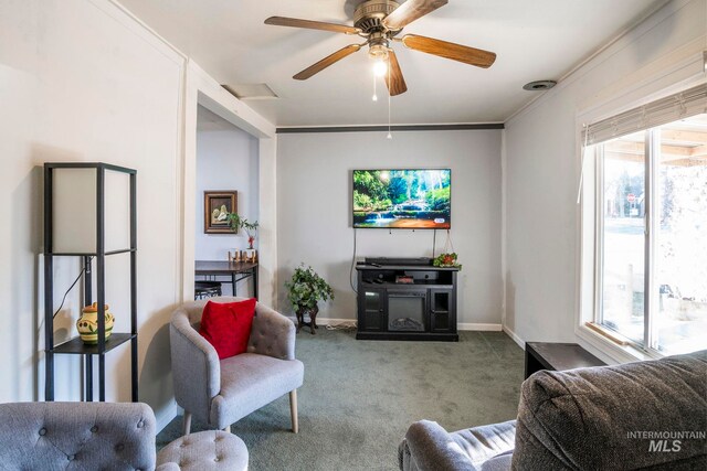 carpeted living room with a ceiling fan, visible vents, and baseboards