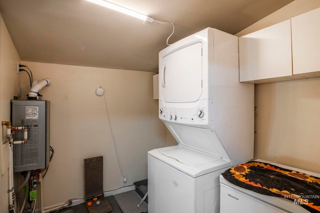 clothes washing area with stacked washer and dryer