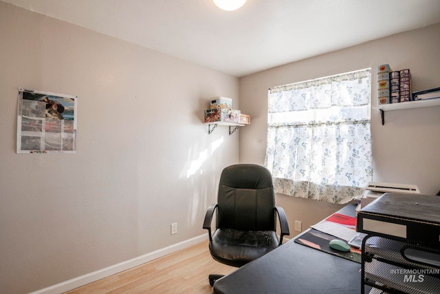 office area featuring baseboards and wood finished floors