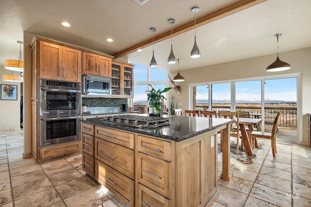 13331 Peaceful Way, Nampa, ID 83686 - kitchen featuring stone tile flooring, a kitchen island, recessed lighting, a textured ceiling, and stainless steel appliances