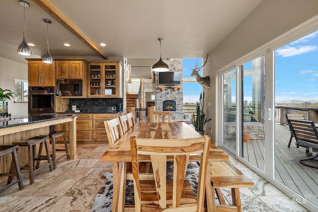 13331 Peaceful Way, Nampa, ID 83686 - dining space featuring recessed lighting, stone tile floors, and a fireplace