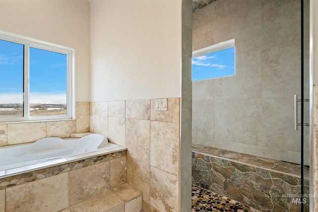 13331 Peaceful Way, Nampa, ID 83686 - bathroom with a garden tub, tile walls, and tiled shower