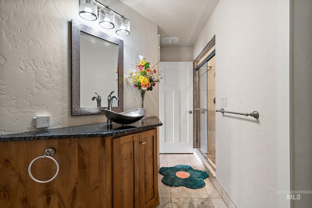 13331 Peaceful Way, Nampa, ID 83686 - full bath featuring a textured wall, a shower stall, tile patterned floors, and vanity