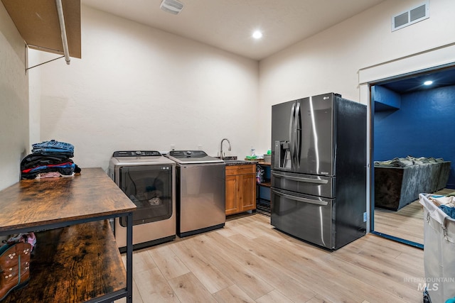 13331 Peaceful Way, Nampa, ID 83686 - clothes washing area featuring light wood-style floors, cabinet space, independent washer and dryer, and visible vents