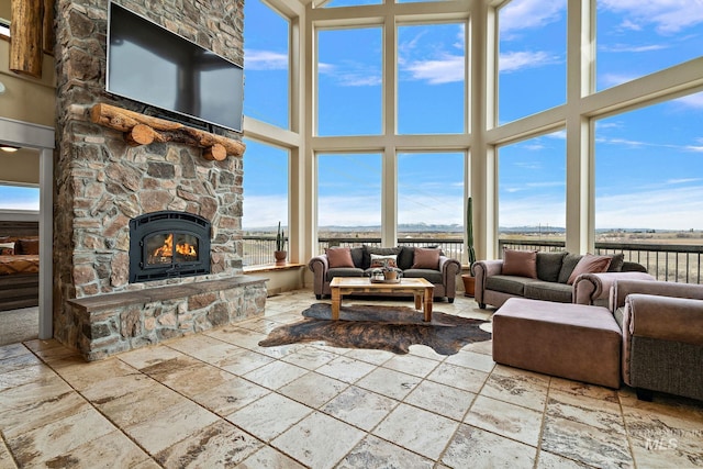 13331 Peaceful Way, Nampa, ID 83686 - living area with stone tile flooring, a water view, a high ceiling, and a stone fireplace