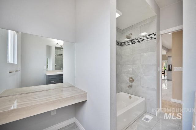 bathroom featuring vanity and tiled shower / bath combo