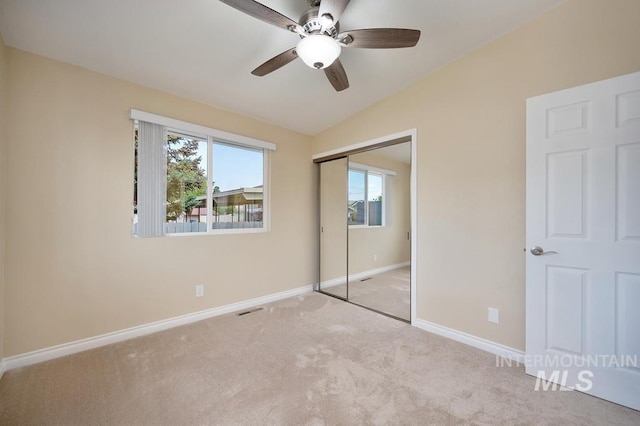 unfurnished bedroom featuring multiple windows, a closet, and ceiling fan