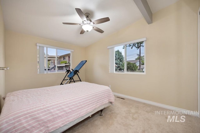 carpeted bedroom featuring ceiling fan and lofted ceiling with beams