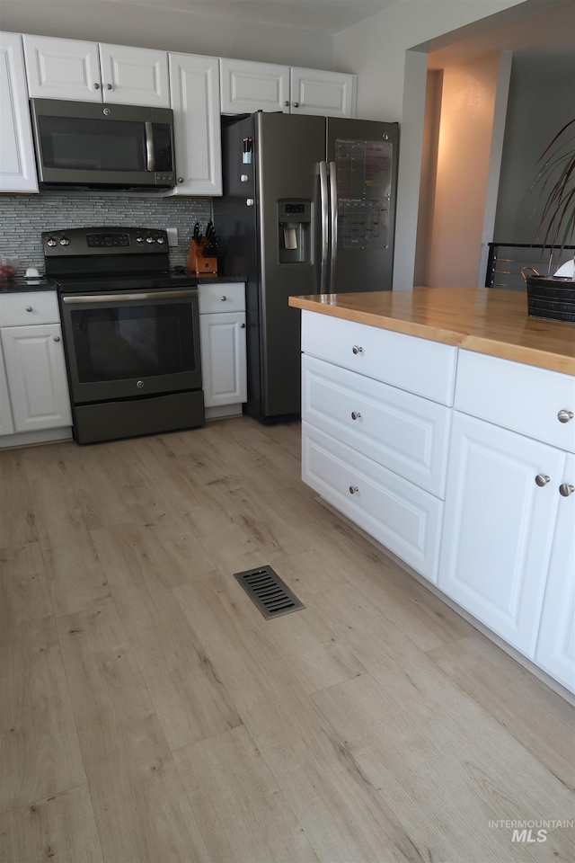 2405 23rd St, Clarkston, WA 99403 - kitchen with electric range, stainless steel refrigerator with ice dispenser, light wood-type flooring, white cabinetry, and backsplash