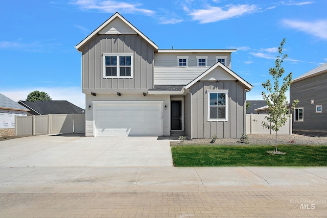 view of front of house with fence, board and batten siding, and driveway