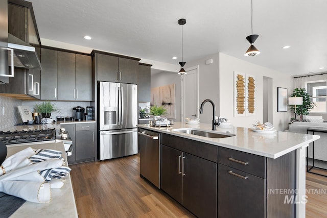 kitchen with a sink, dark wood finished floors, open floor plan, and stainless steel appliances