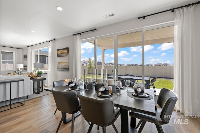 dining space with recessed lighting, visible vents, and light wood-style flooring