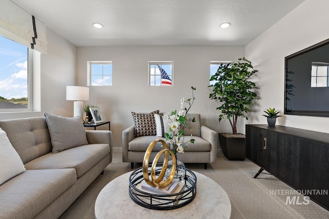 living area featuring recessed lighting and light colored carpet