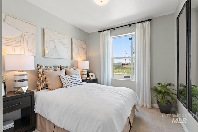 carpeted bedroom featuring baseboards