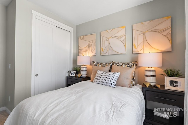 bedroom with a closet and baseboards