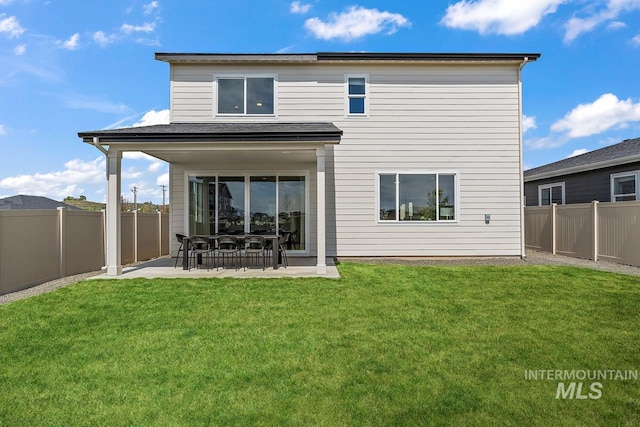 back of property featuring a patio area, a yard, and a fenced backyard