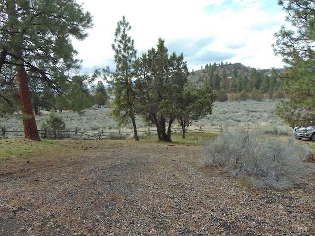 view of yard featuring a rural view and fence