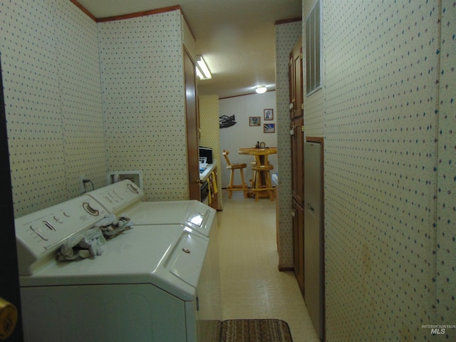 laundry area featuring laundry area, washing machine and dryer, and light floors