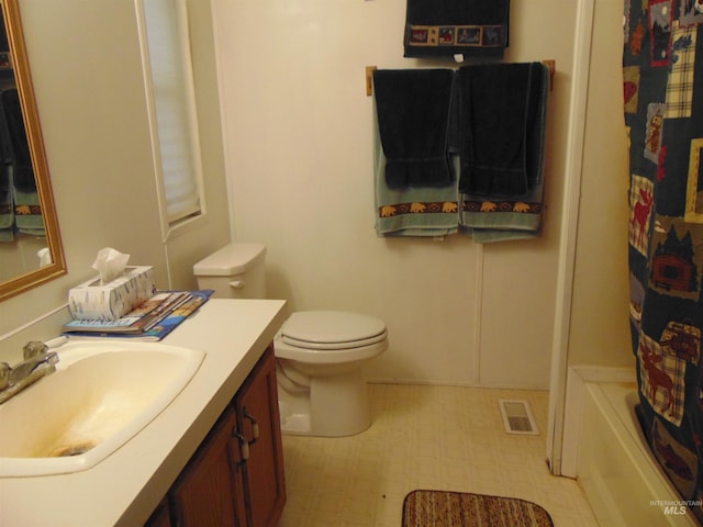 bathroom featuring tile patterned floors, vanity, visible vents, and toilet