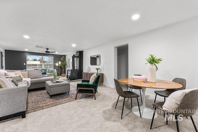 carpeted living room featuring ceiling fan