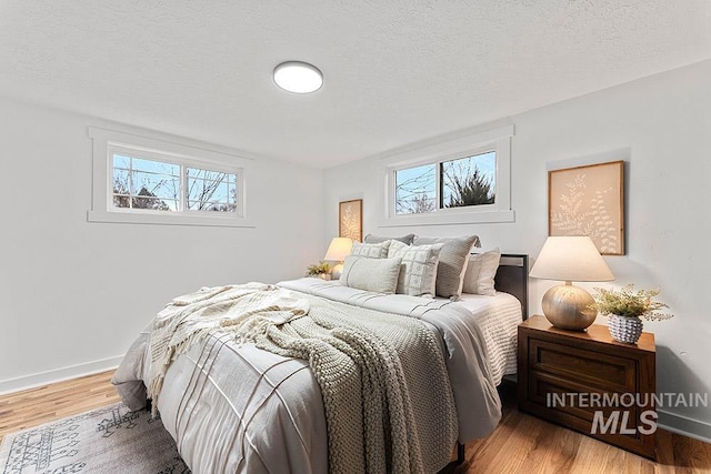 bedroom featuring hardwood / wood-style floors and a textured ceiling