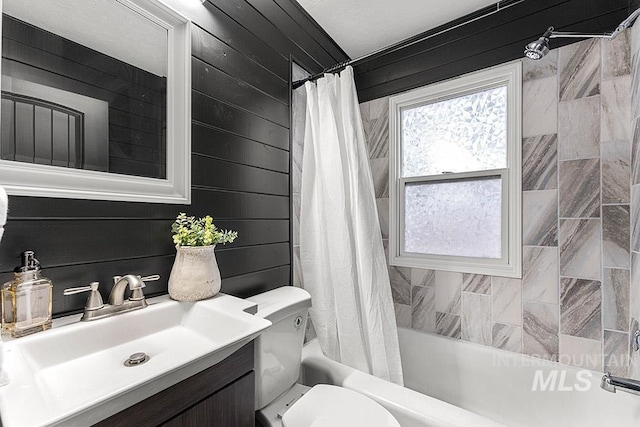 full bathroom featuring vanity, shower / tub combo, wood walls, and toilet