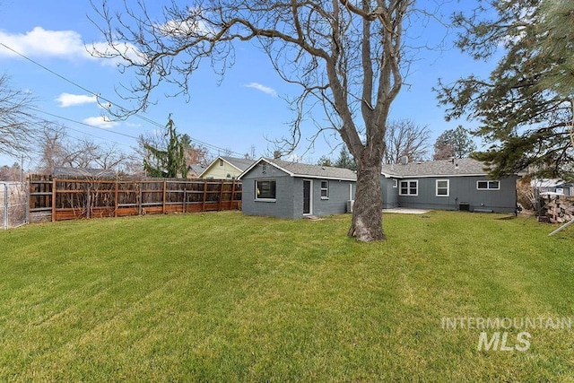 back of house with a yard and a patio